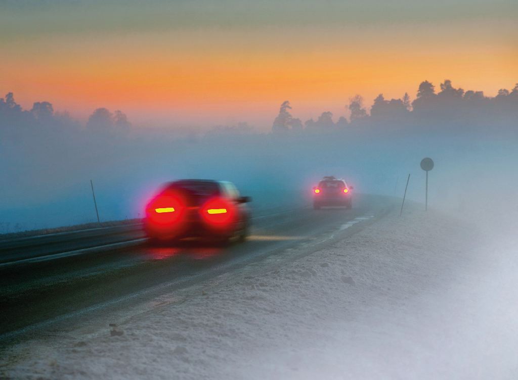 Zwei Autos auf einer nebeligen und glatten STraße